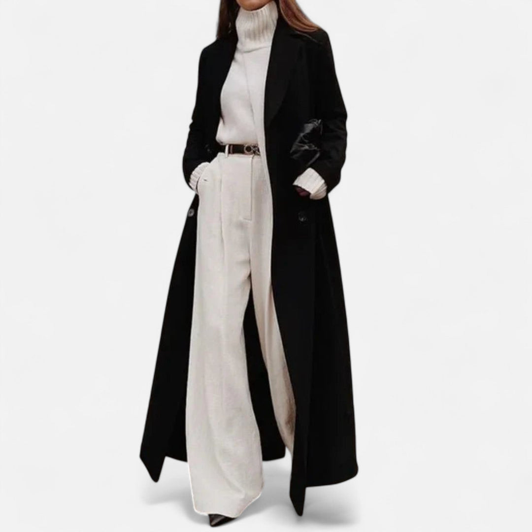 Classic women's black maxi coat, featuring a sleek tailored design for an elegant, versatile autumn/winter look.