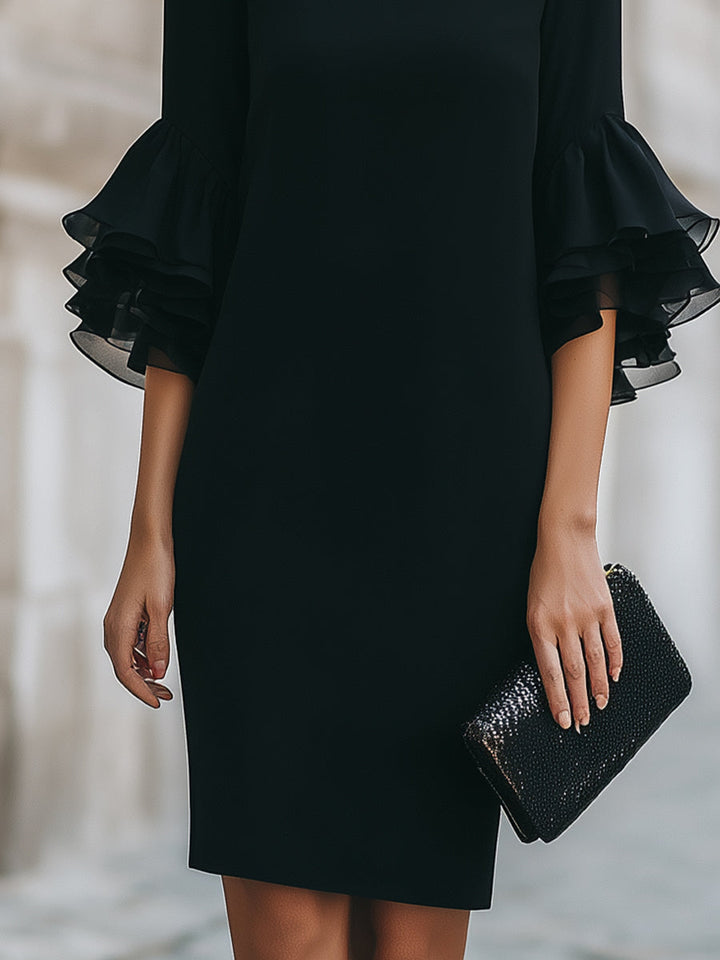 Women's black midi dress with elegant ruffled sheer sleeves. A sophisticated and timeless choice for any formal event.