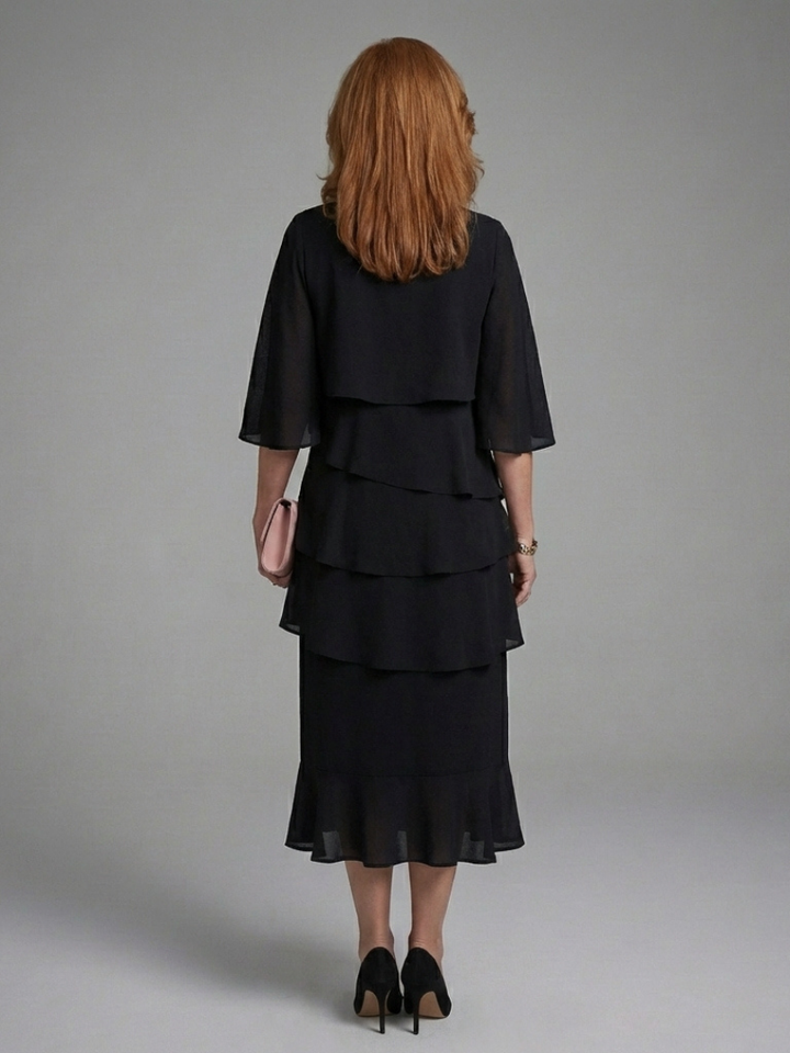 Stylish women's black midi dress with a flowing layered cape sleeve design, offering an elegant & sophisticated look.