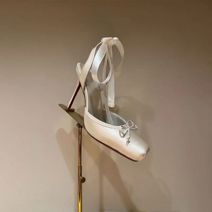 Detailed view of women's platform ankle strap court shoes, highlighting the elegant heel and secure closure.