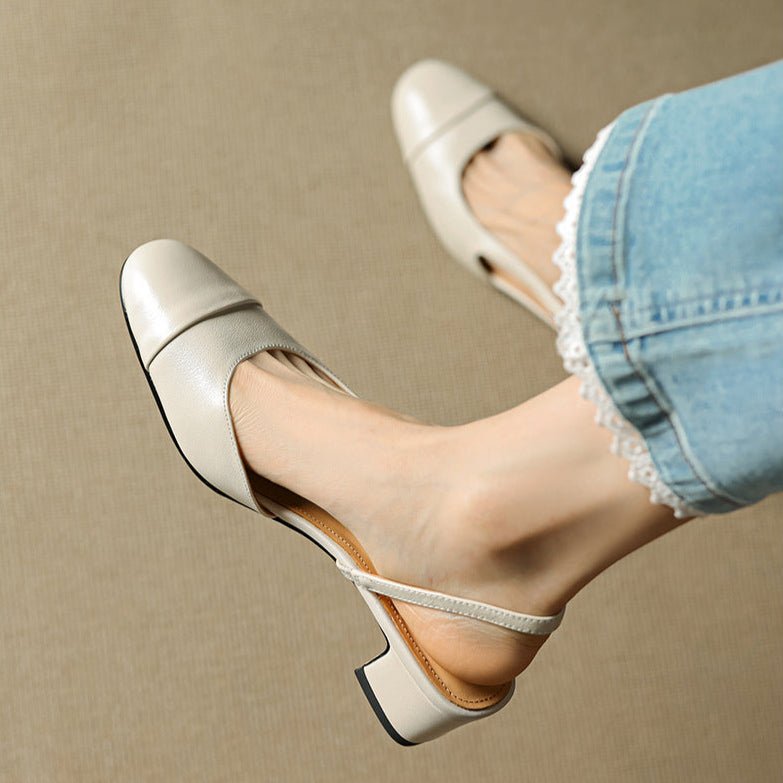 Fashionable women's black slingback block heel pumps, a classic choice for formal and work outfits.