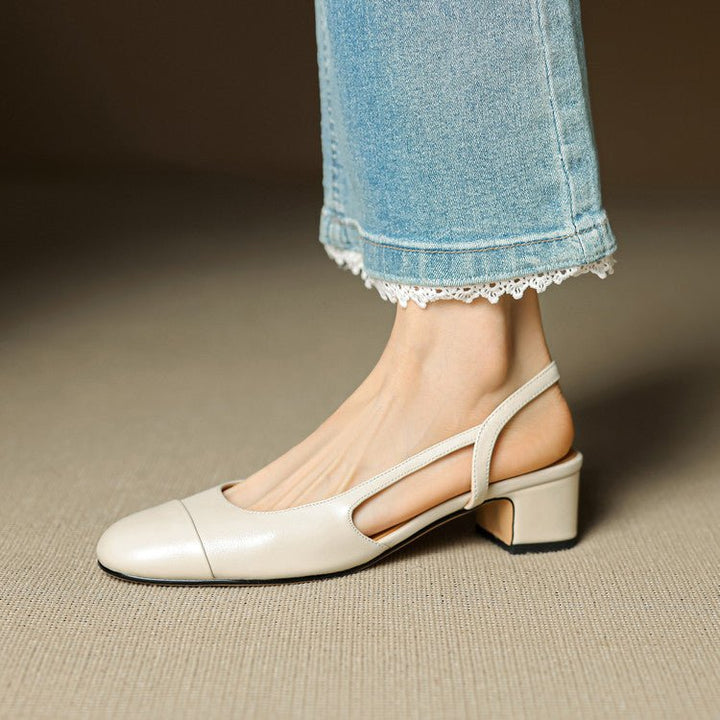 Elegant women's black slingback pumps with a comfortable block heel, perfect for professional attire.