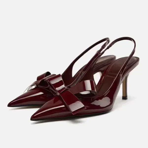 Close-up of a stylish women's stiletto heel featuring a delicate bow and pointed toe