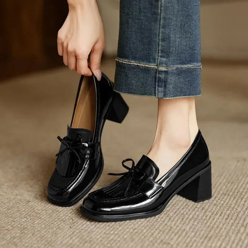 Women's elegant black tassel loafer pumps with comfortable block heel & round toe, perfect for office wear.