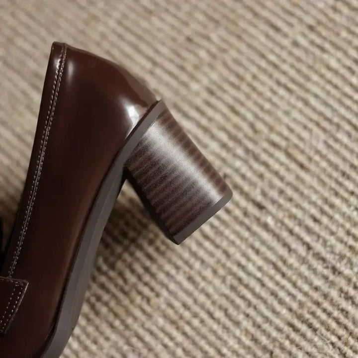 Comfortable women's elegant brown pumps, featuring a block heel, round toe, and charming tassel accents.