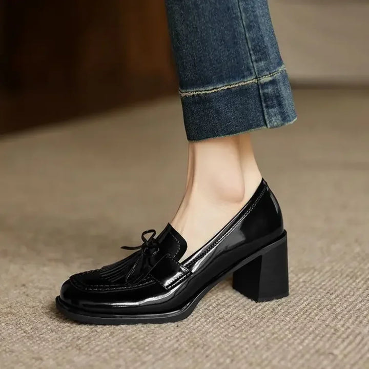 Classic brown women's loafer pumps featuring stylish tassels, a comfortable block heel & chic round toe.