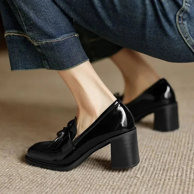 Formal black block heel pumps for women, designed with sophisticated tassels and a comfortable round toe.
