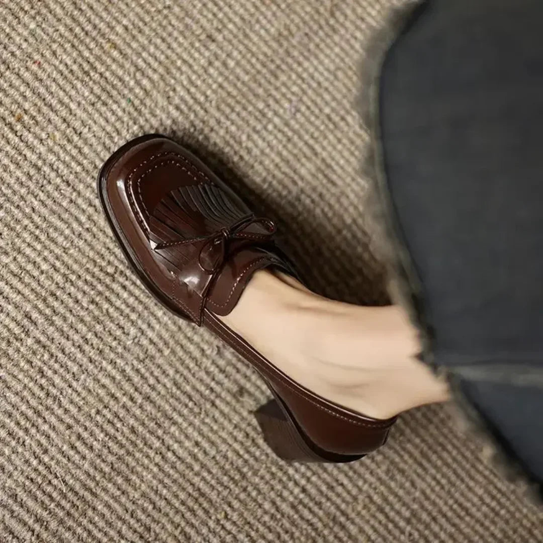 Sophisticated women's black formal pumps, featuring classic tassels, a comfortable block heel & round toe.