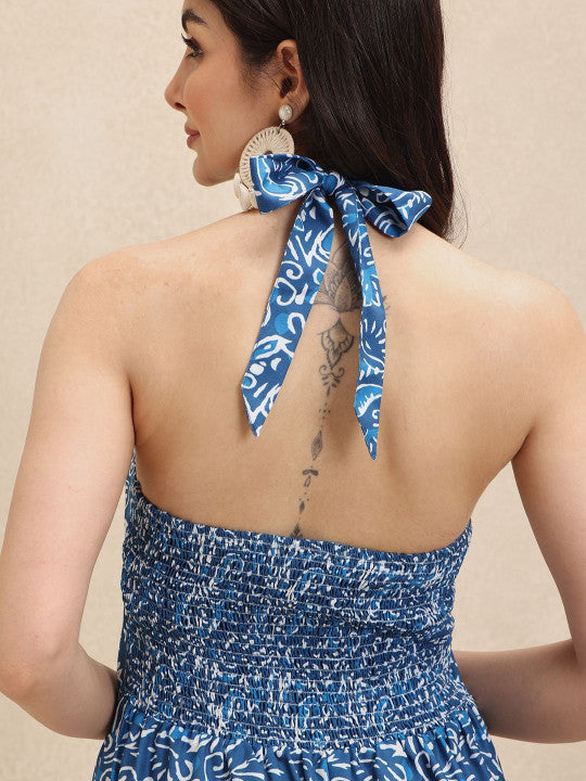 Stylish women's blue floral halterneck maxi dress with a flowing A-line cut, great for elegant summer style.