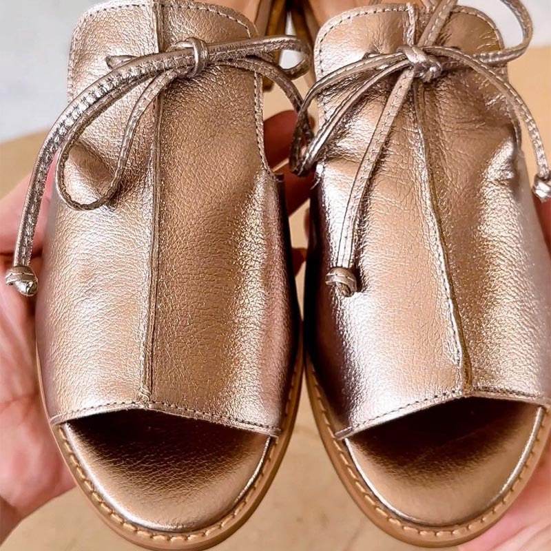 Adjustable fit women's strap sandals with bow detail, comfortable and stylish for warm weather.