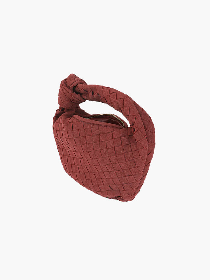 Elegant suede mini bag with unique braided design and compact size.