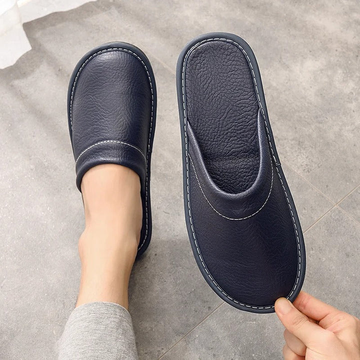 Close-up of luxurious brown leather slippers, showcasing comfort and style for women.