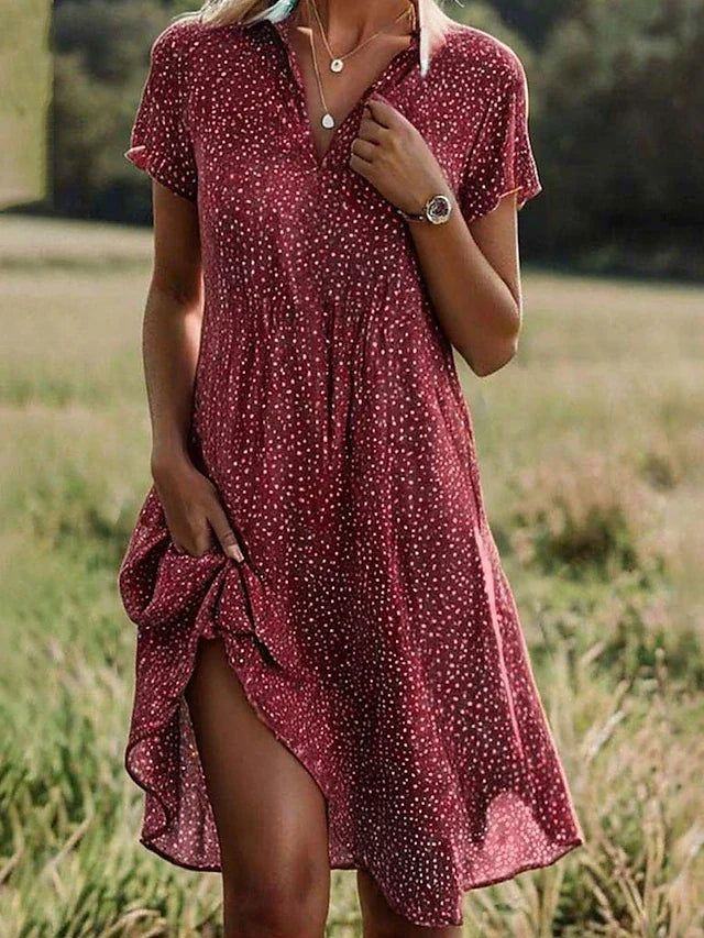 Stylish women's midi shirt dress with button-down front, ideal for casual or elegant everyday wear. Short sleeve design.