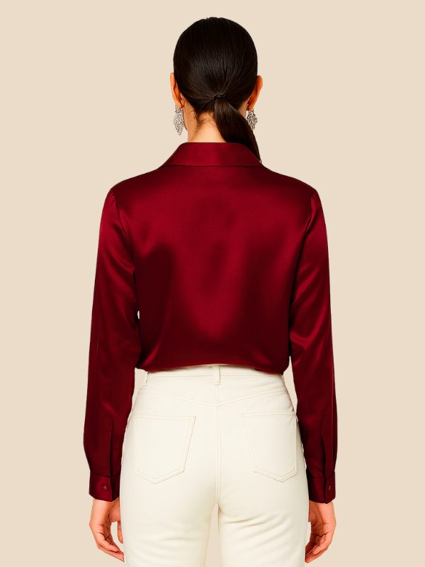 Elegant women's button-down shirt, long sleeve, pointed collar, styled on a model.