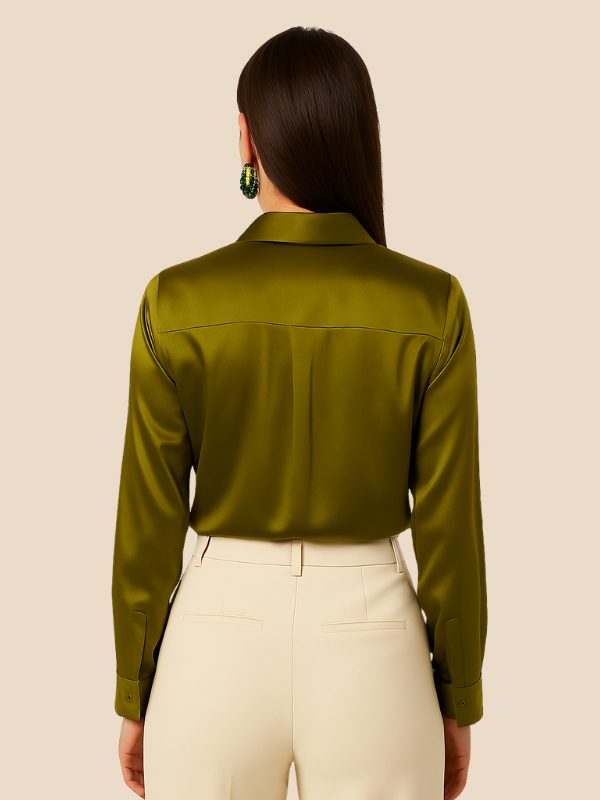 Women's white button-down shirt with pointed collar, long sleeve, untucked look.
