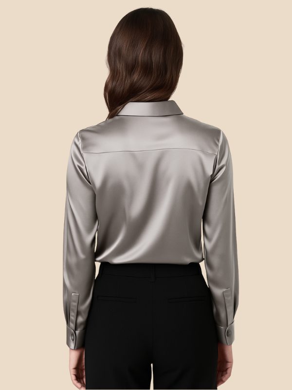 Close-up: pointed collar and buttons of women's elegant button-down shirt.