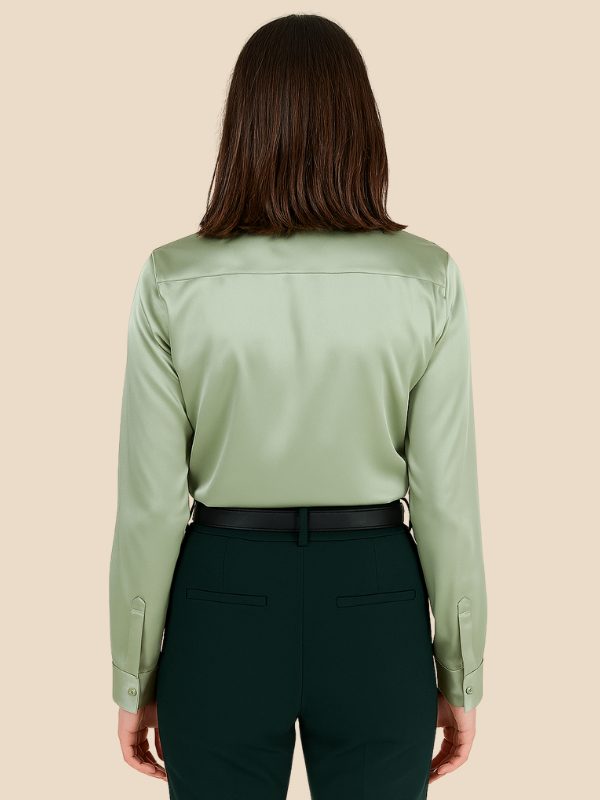 White women's office button-down shirt, long sleeve, sharp pointed collar.