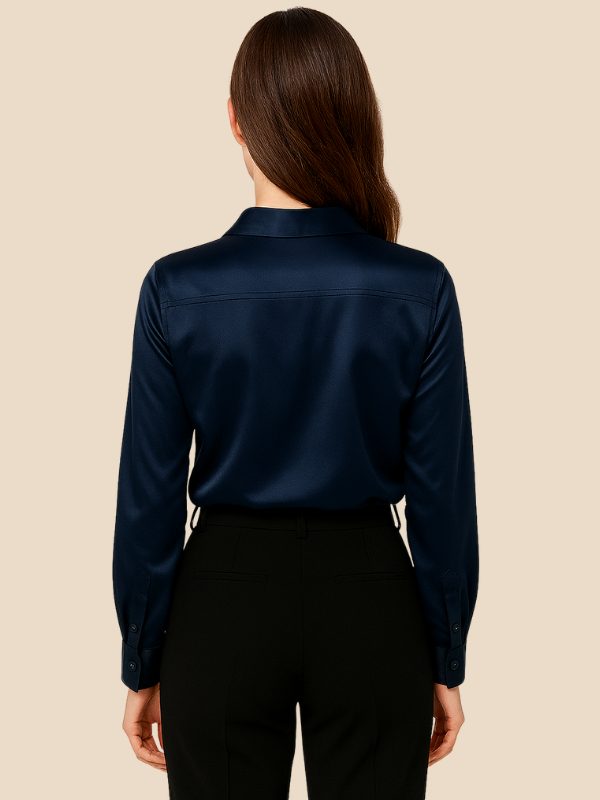Women's tailored button-down shirt, long sleeve, elegant pointed collar, in light color.