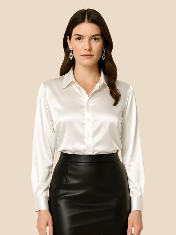 Elegant women's button-down shirt, long sleeve, pointed collar, on a mannequin.