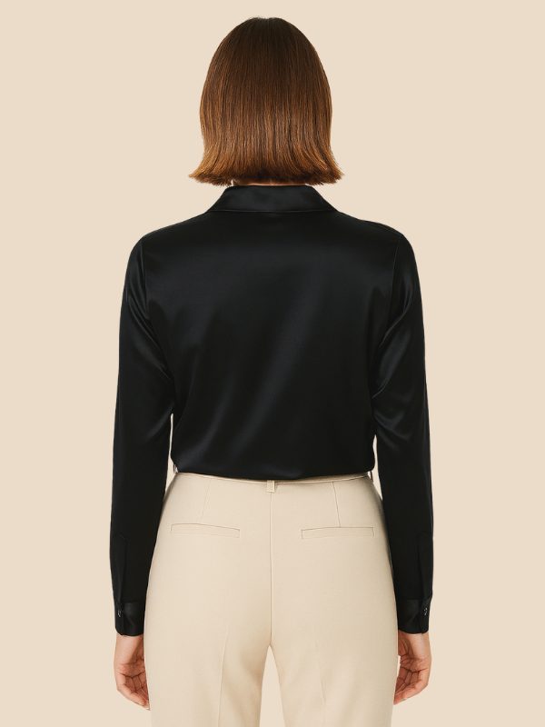 Light blue women's long sleeve button-down shirt, pointed collar, tailored fit.