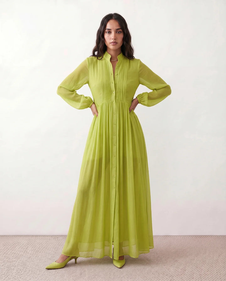 Woman wearing a flowy button-front maxi dress on a beach, ideal for summer vacation and sundress style.