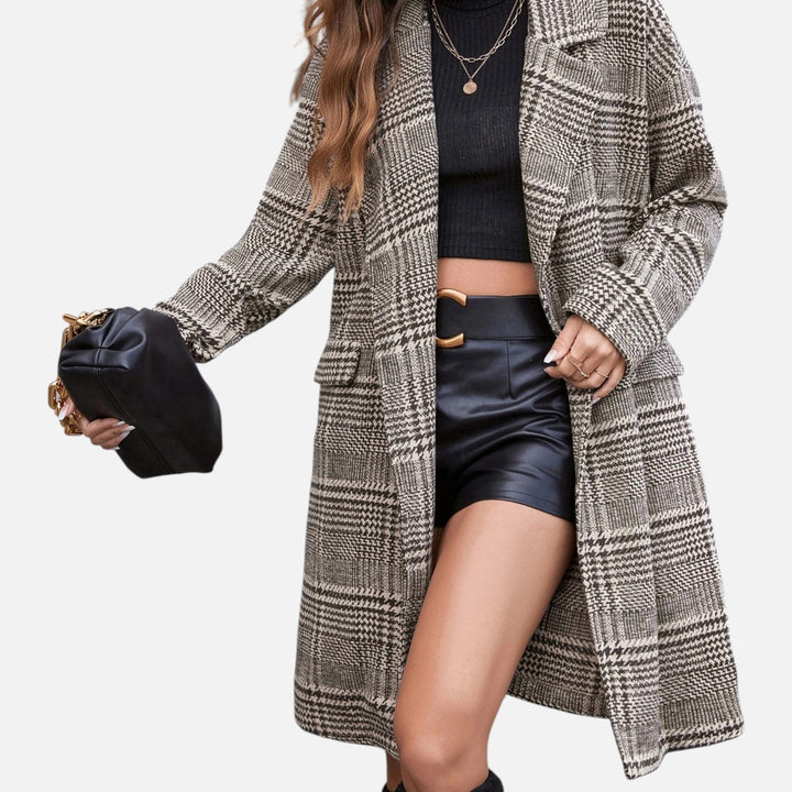 Tailored women's checkered blazer, featuring a button-up lapel. Ideal for professional wear or casual chic spring style.