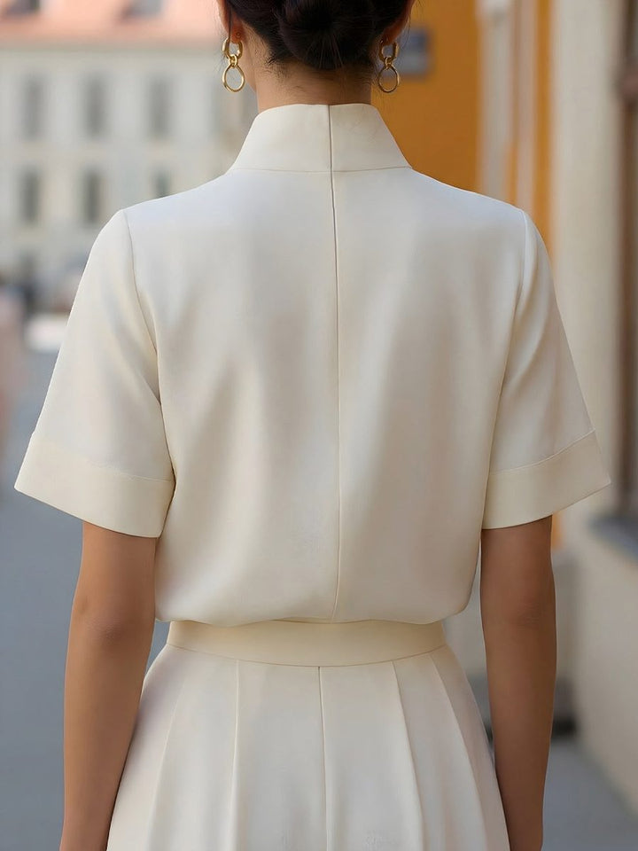 Modern ladies' cropped top featuring a sophisticated stand collar and short sleeves, ideal for workwear or summer.