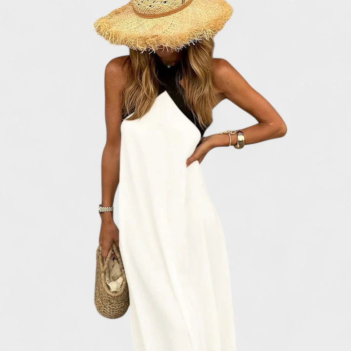 Elegant women's sleeveless maxi dress with a stylish cross-neck, ideal for summer and evening.