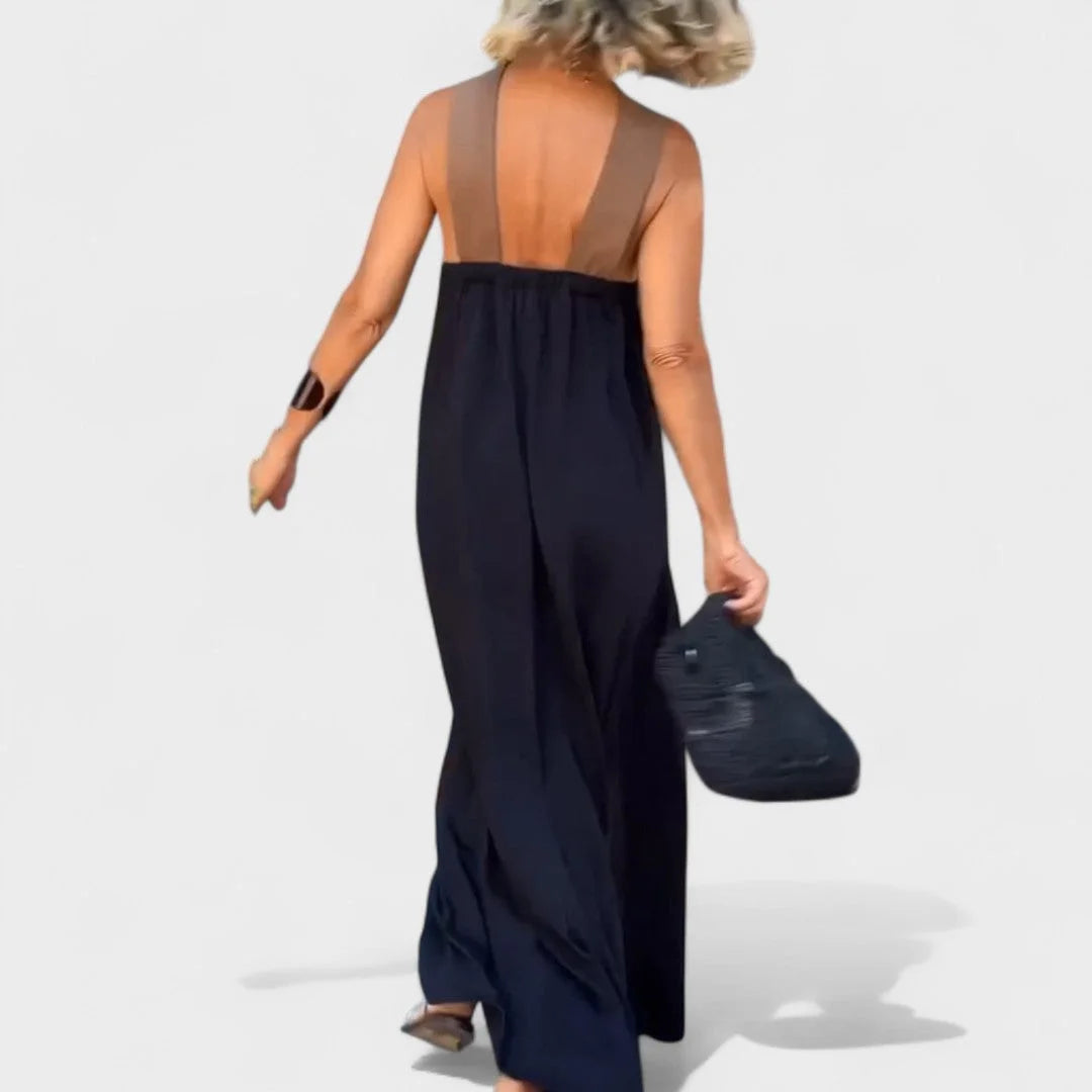 Flowy women's sleeveless maxi dress with an elegant cross-neck, perfect for comfort & style.