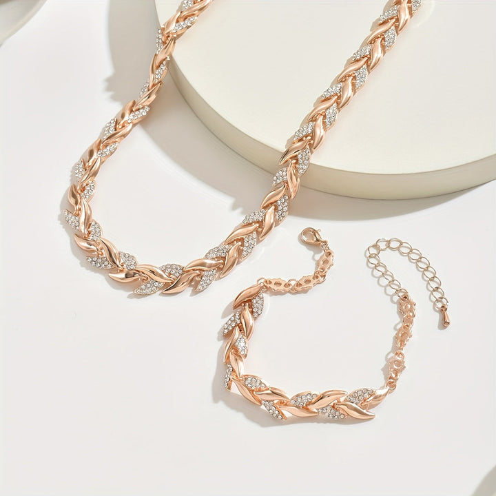 Women's elegant crystal leaf necklace and matching chain bracelet set. Sparkling rose gold jewelry gift.