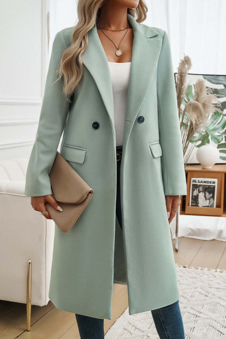 Stylish women's long double-breasted coat, an essential for elegant fall outerwear collections.