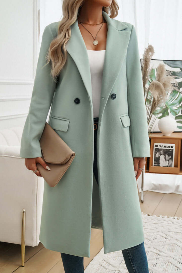 Stylish women's long double-breasted coat, an essential for elegant fall outerwear collections.