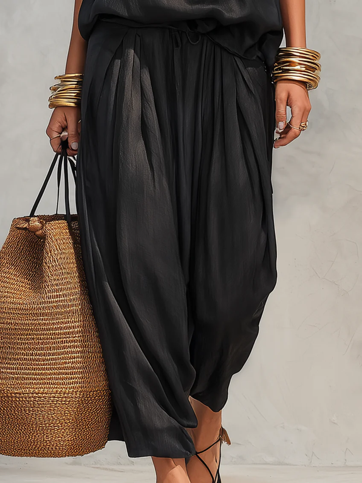 Women's elegant draped two-piece outfit featuring a chic cowl neck top and comfortable wide-leg trousers for women.