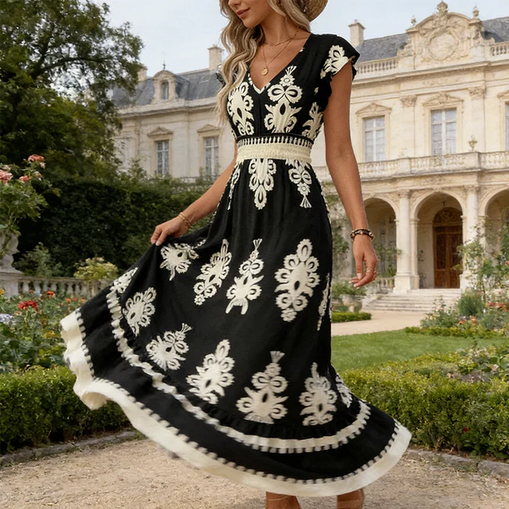 Chic women's V-neck summer dress with intricate embroidery, perfect for elegant occasion wear.