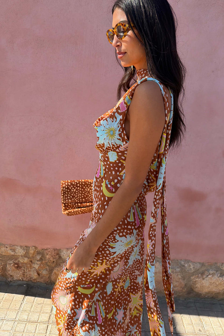 Women's occasion wear fawn print maxi dress. Features a graceful cowl neck and stylish halter design.
