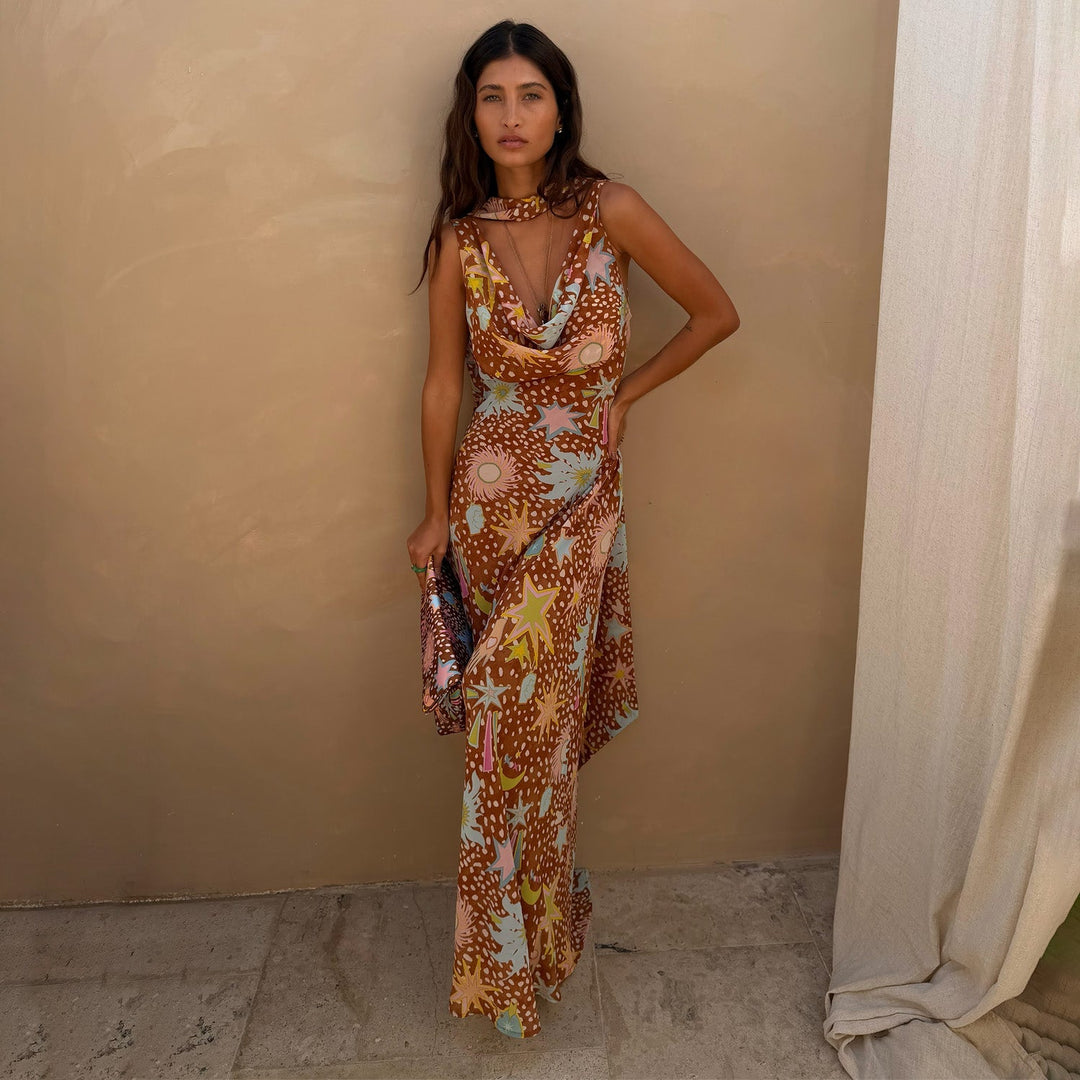 Chic women's fawn print maxi dress featuring a cowl neck, halter top, & elegant low back detail. Vacation ready.