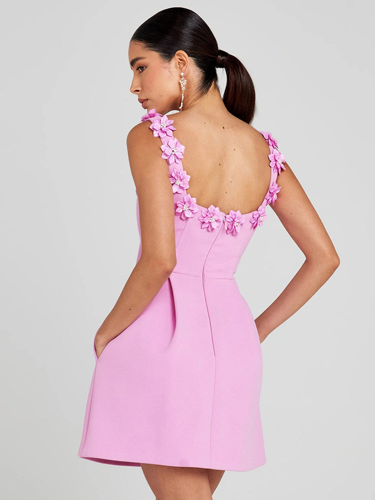 Close-up of women's short floral dress with intricate embellishments, ideal for evening wear.