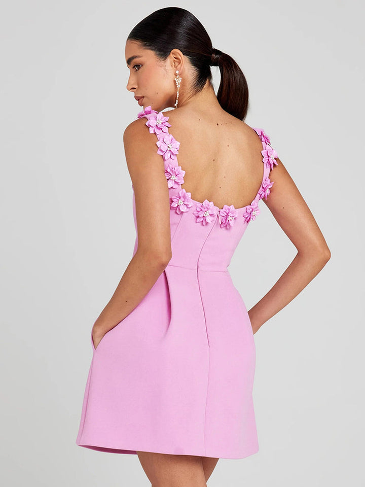 Close-up of women's short floral dress with intricate embellishments, ideal for evening wear.