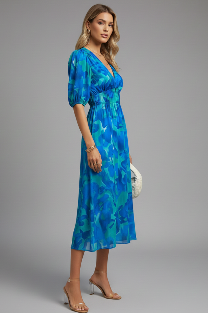 Model wearing an A-line floral midi dress with puff sleeves & V-neck, ideal for daytime or casual formal events.