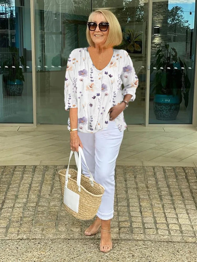 Model wearing a relaxed fit women's floral blouse, ideal for versatile everyday and casual chic summer wear.
