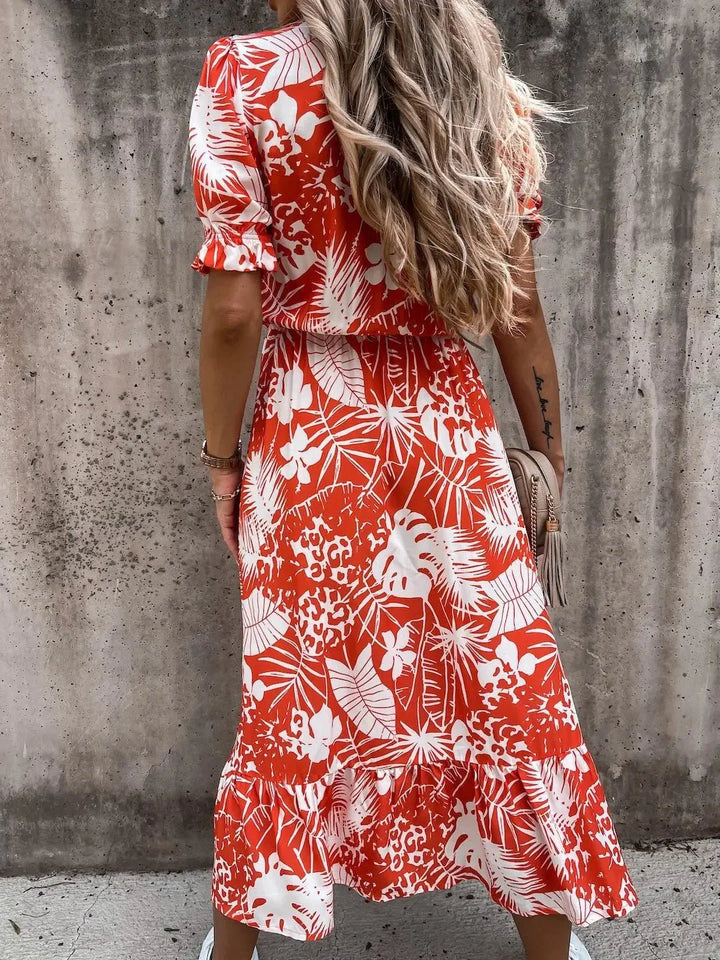 Chic women's floral print dress, elegant summer style for garden parties and warm days.
