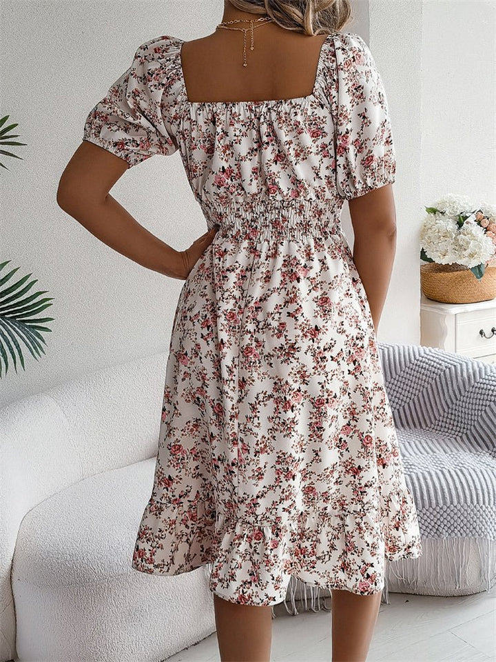 Flowy women's floral print midi dress with smocked bodice and fashionable puff sleeves.