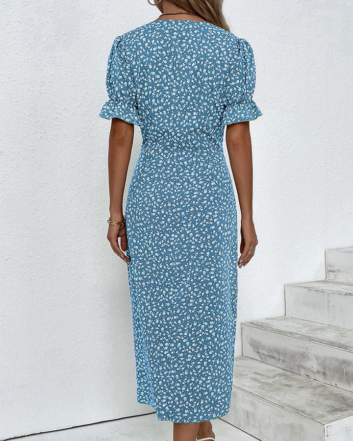 Side view of a woman wearing a chic floral V-neck wrap midi dress, showcasing its flattering drape.