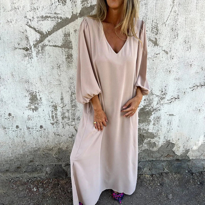 Women's elegant flowy V-neck maxi dress with stylish bishop sleeves & practical pockets, perfect for summer.