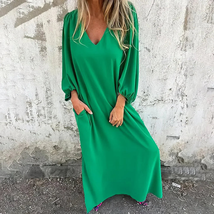 Stylish women's summer maxi dress, featuring a deep V-neckline, voluminous bishop sleeves, and side pockets.