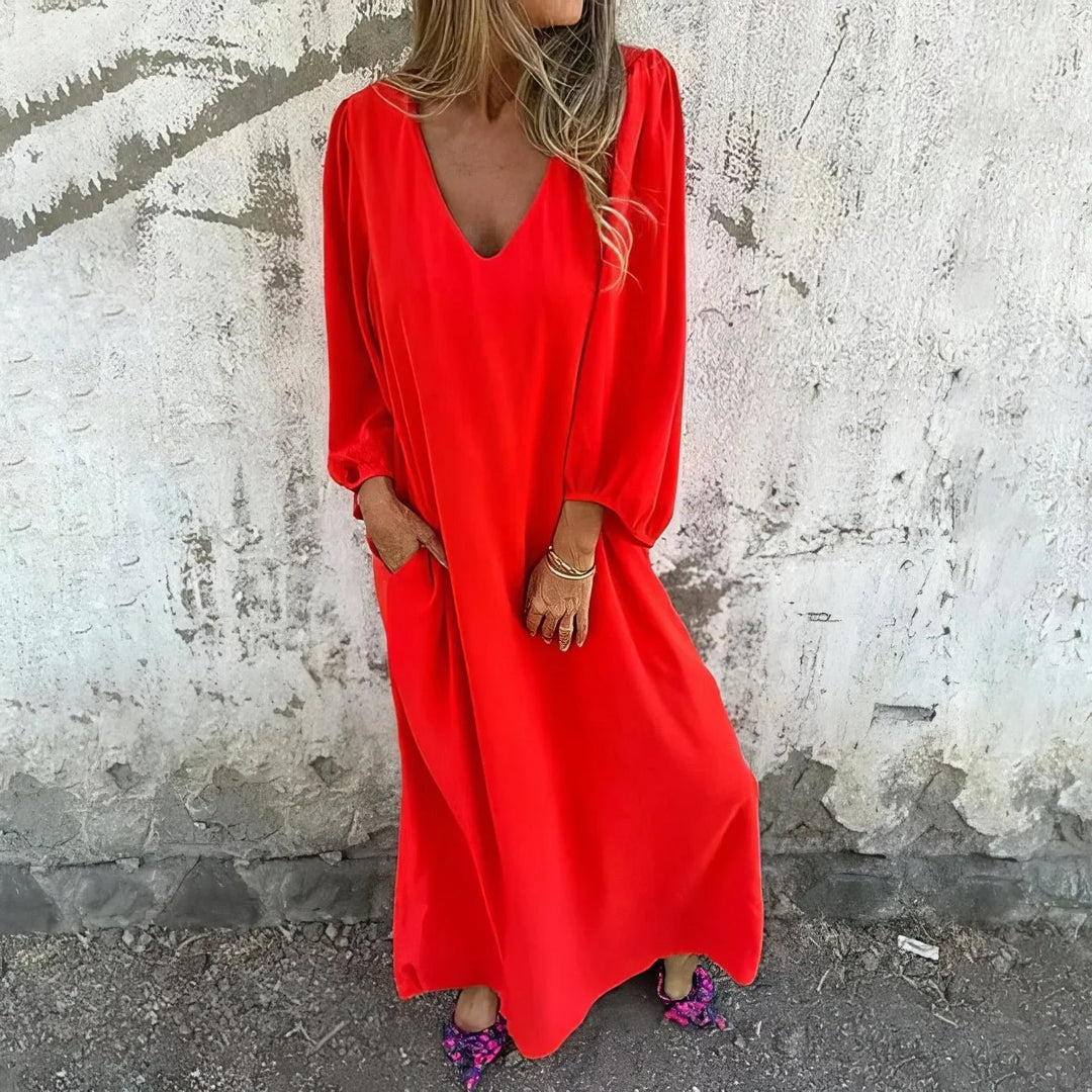 Elegant long flowy maxi dress for women with V-neck, bishop sleeves & essential pockets, great for casual wear.