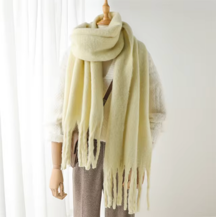 Close-up on the premium fabric of the elegant, warm, and cozy fringe scarf.