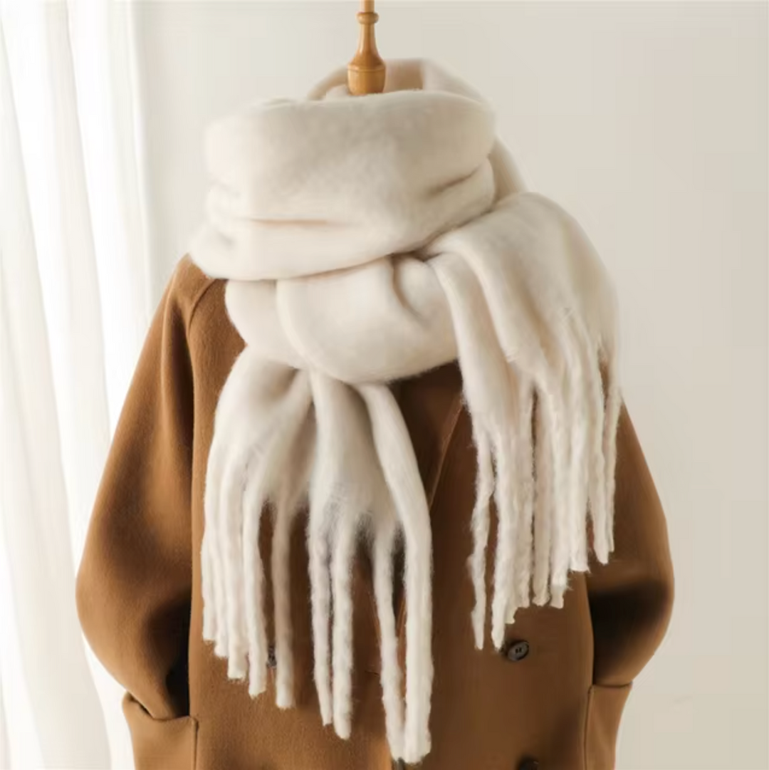 Detailed view of the intricate fringe detail on an elegant women's winter scarf.