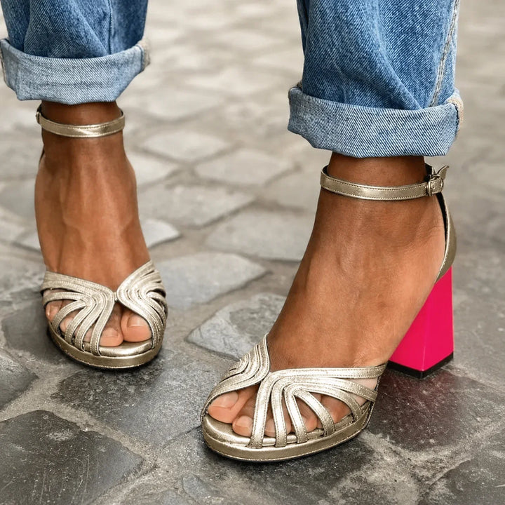 Women's elegant gold strappy sandals with stylish pink block heel, perfect for summer parties & evening events.