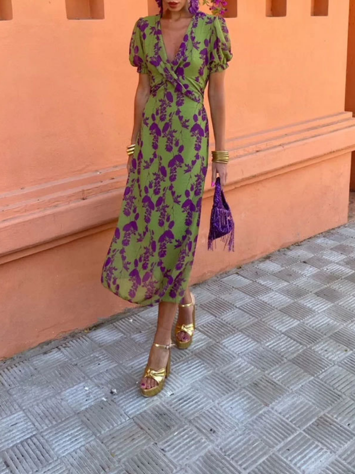 Close-up of a stylish green floral print on a V-neck short sleeve midi dress, showing intricate fabric detail.